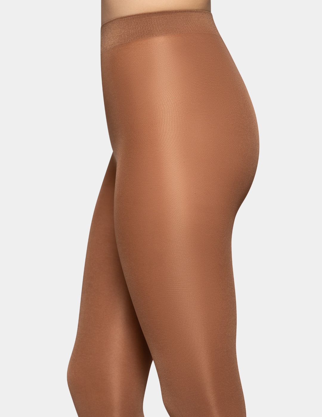 A close-up of a model wearing opaque caramel colored tights against a light gray background.