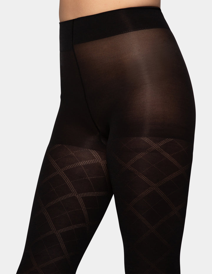 Black sheer tights with a subtle diamond grid pattern on the lower legs, shown on a model from the waist down against a light gray background.
