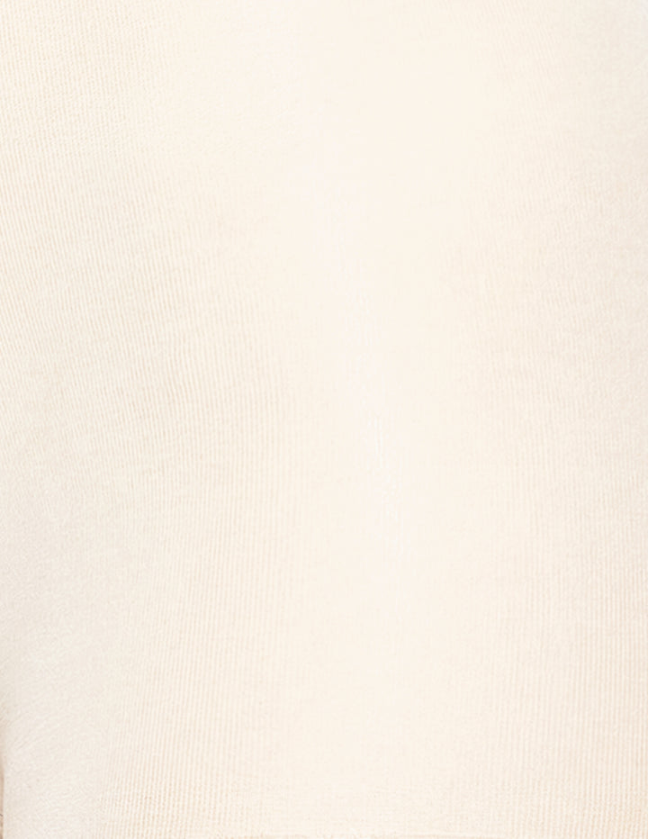 A close-up of a light cream or off-white ribbed knit fabric texture.