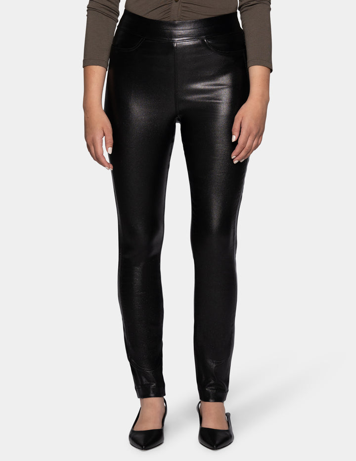 A model wearing coated black pants, a grey 3/4 sleeve top, and black flats photographed against a light gray background.