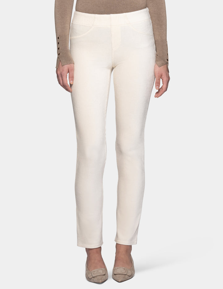 A model wearing off white corduroy pants with a long sleeve beige top and matching color shoes