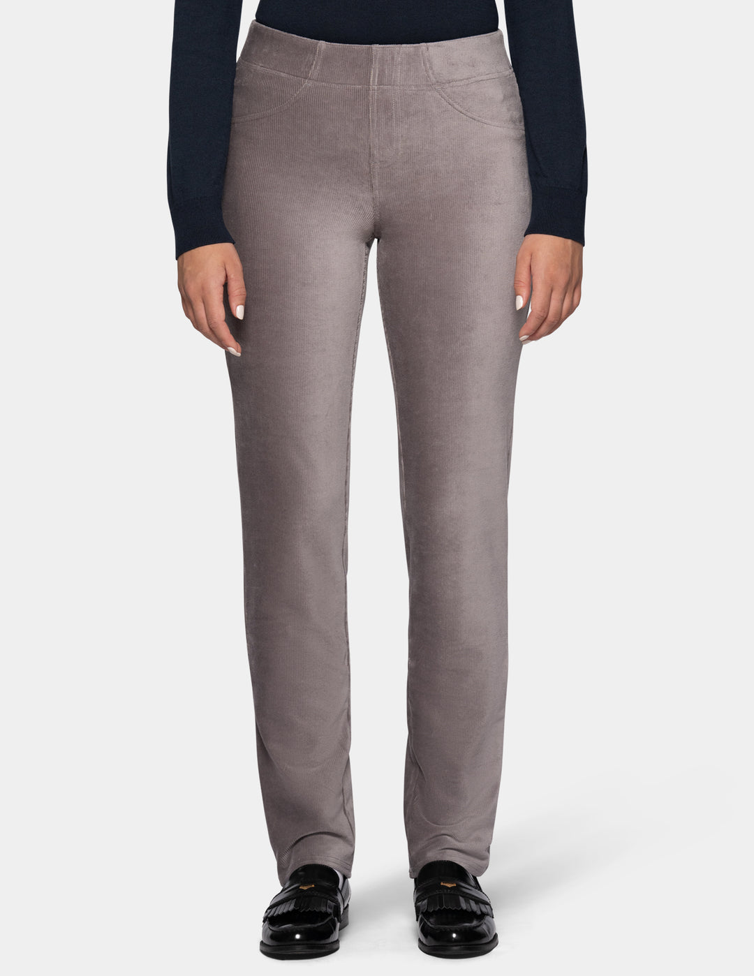 A model wearing grey corduroy pants from the waist down with a long sleeve black top and black shoes