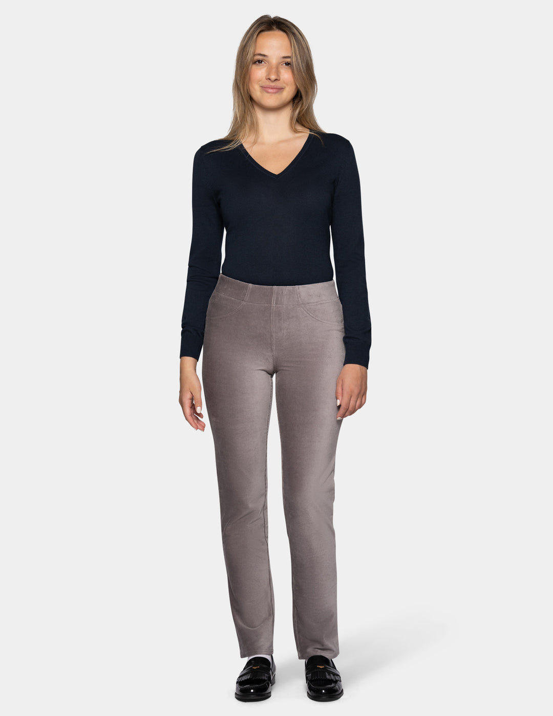 A model wearing grey corduroy pants with a long sleeve black top and black shoes