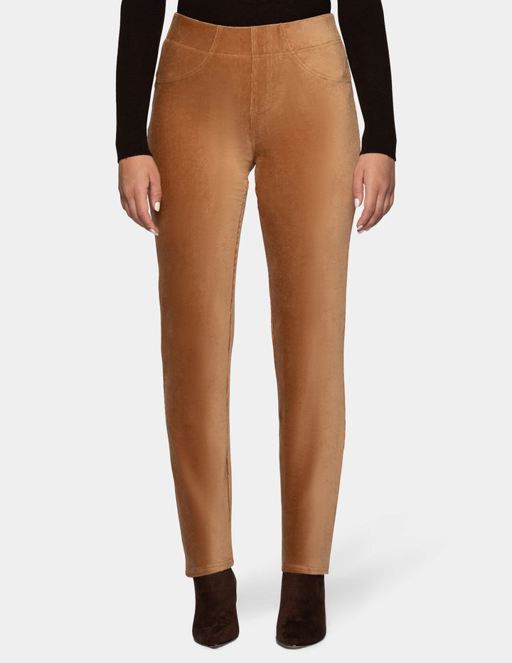 A model wearing tan corduroy pants with a long sleeve black top and dark brown shoes