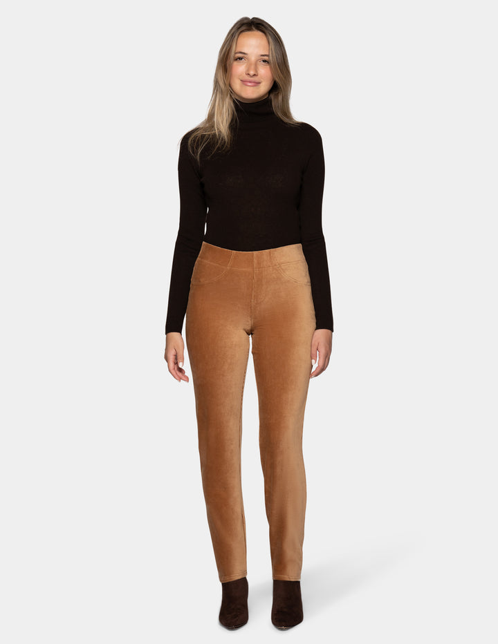 A model wearing tan corduroy pants with a long sleeve black top and dark brown shoes