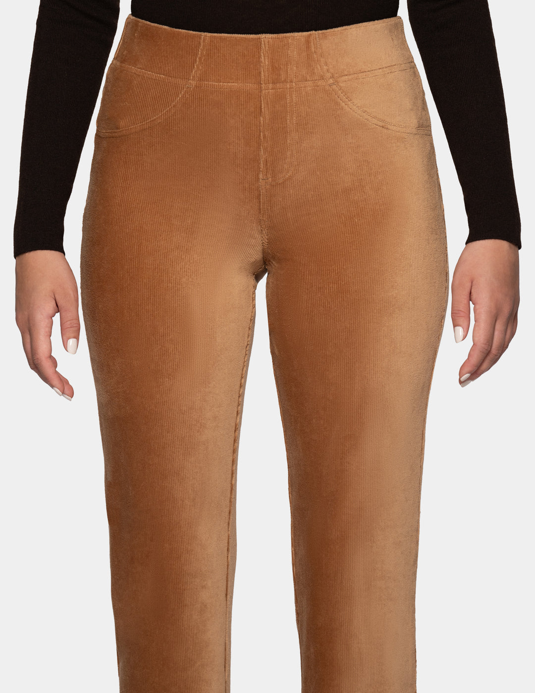 A close-up view of a model wearing tan corduroy pants with a long sleeve black top