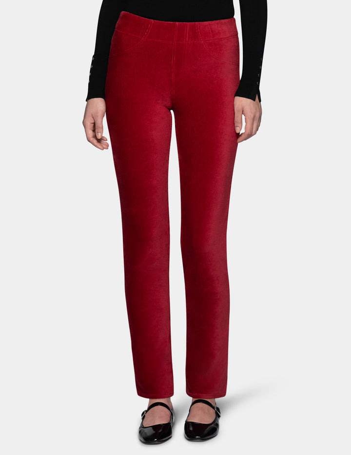 A model wearing red corduroy pants with a long sleeve black top and black shoes