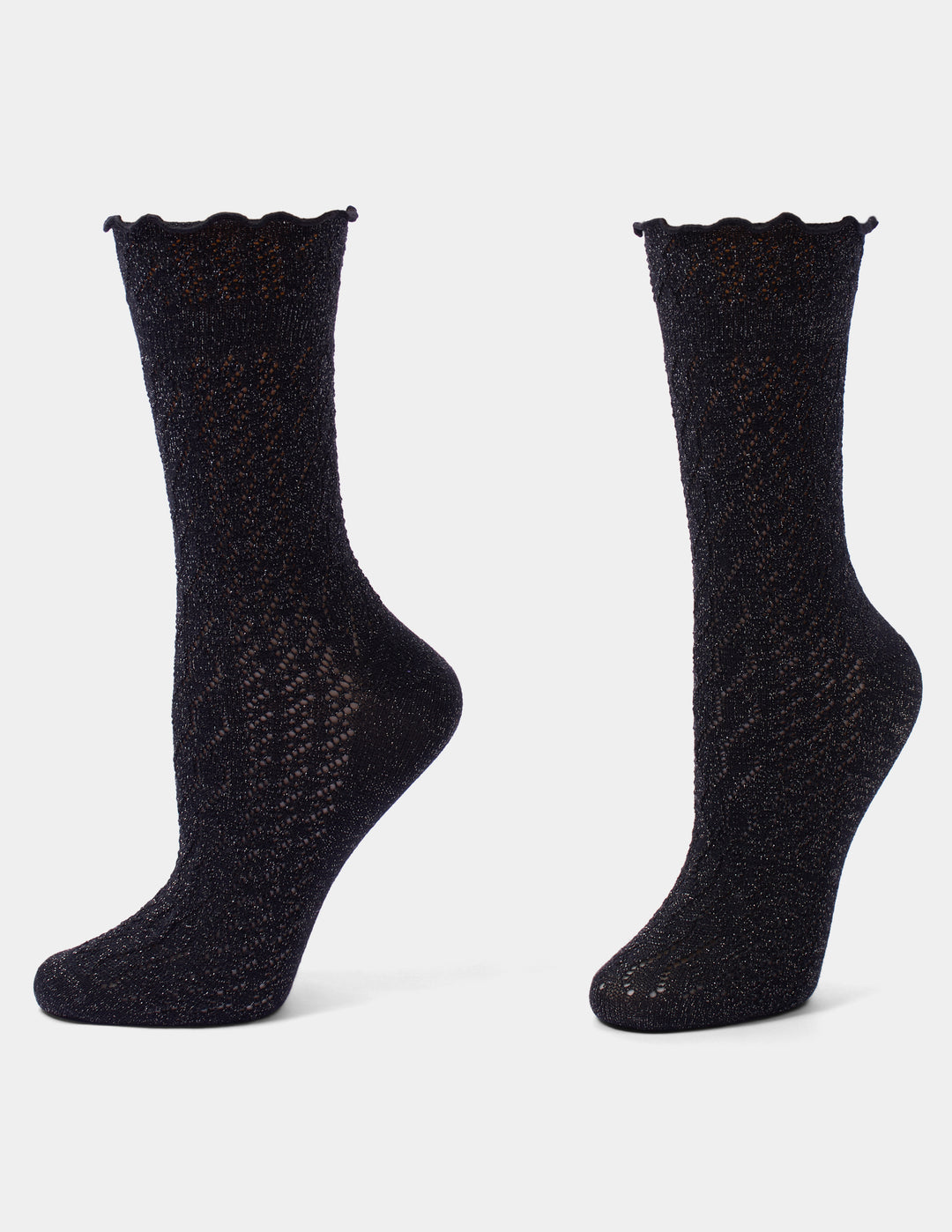 Black pointelle crew socks with metallic accents and a ruffle edge displayed against a light gray background.