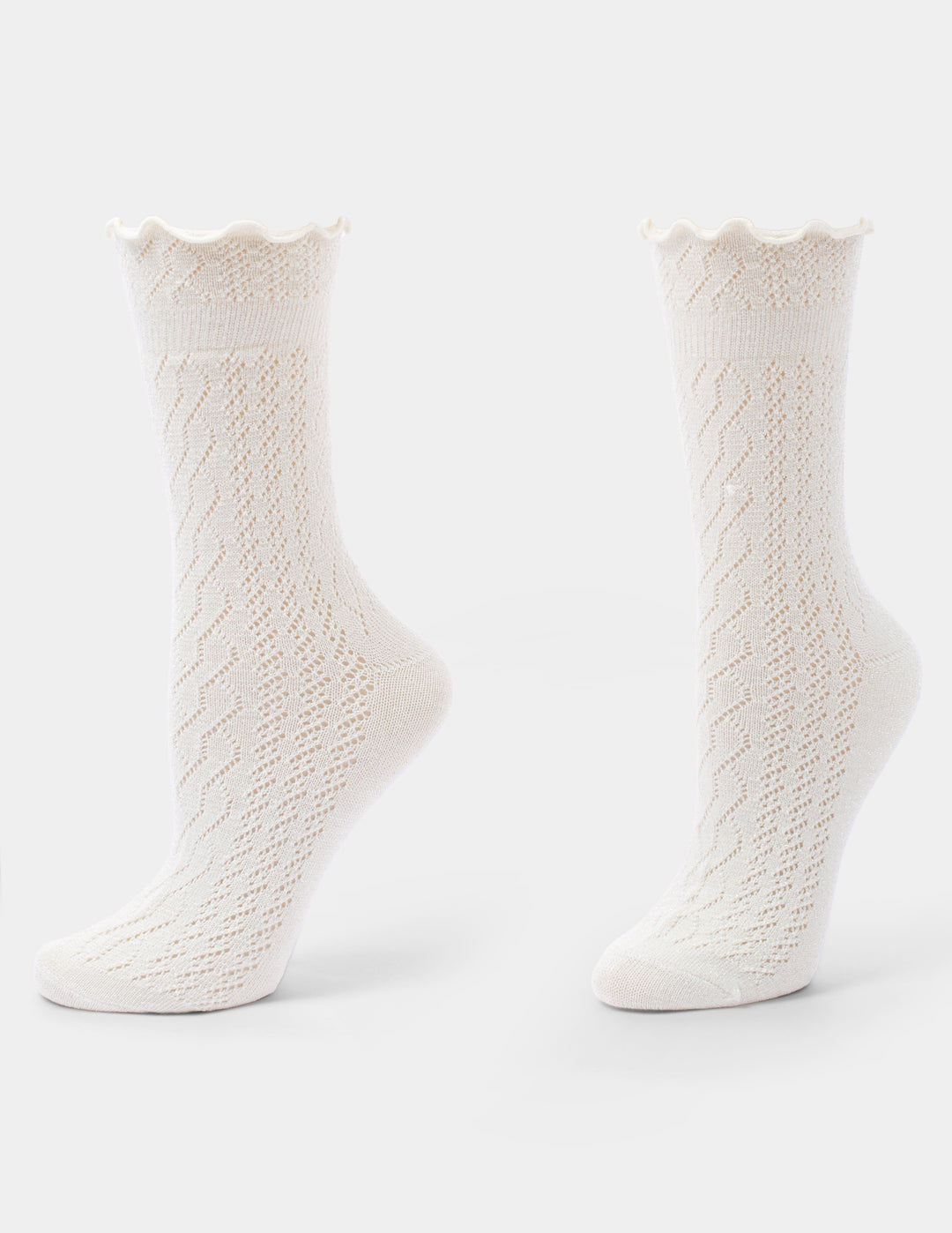 Ivory crew socks with a ruffle edge displayed against a light grey background.