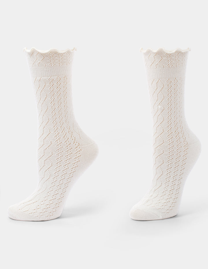 Ivory crew socks with a ruffle edge displayed against a light grey background.