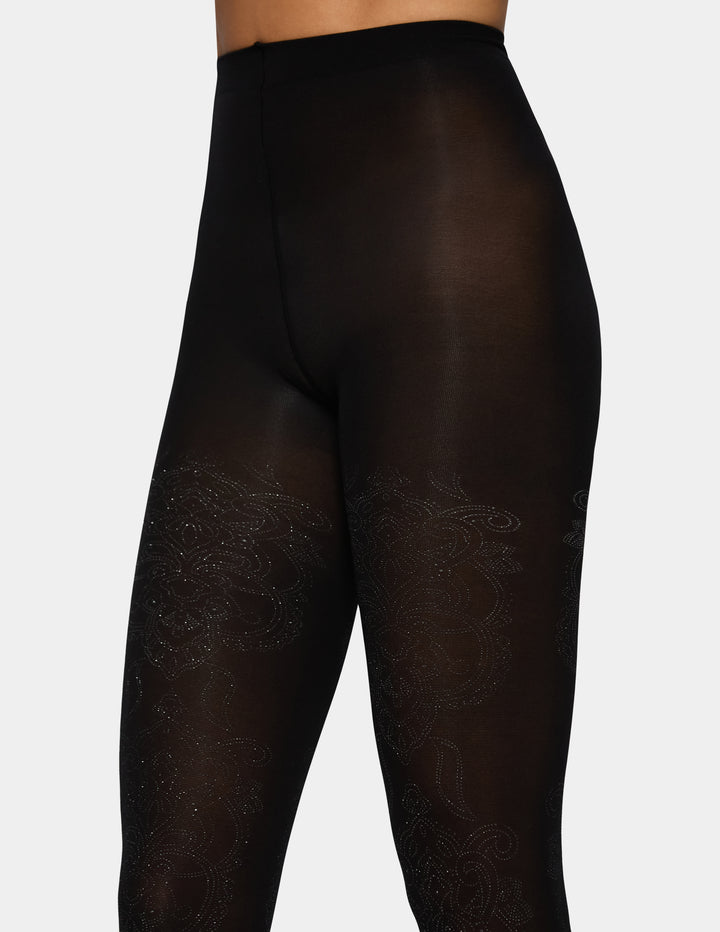 A model wearing black tights photographed against a light grey background.