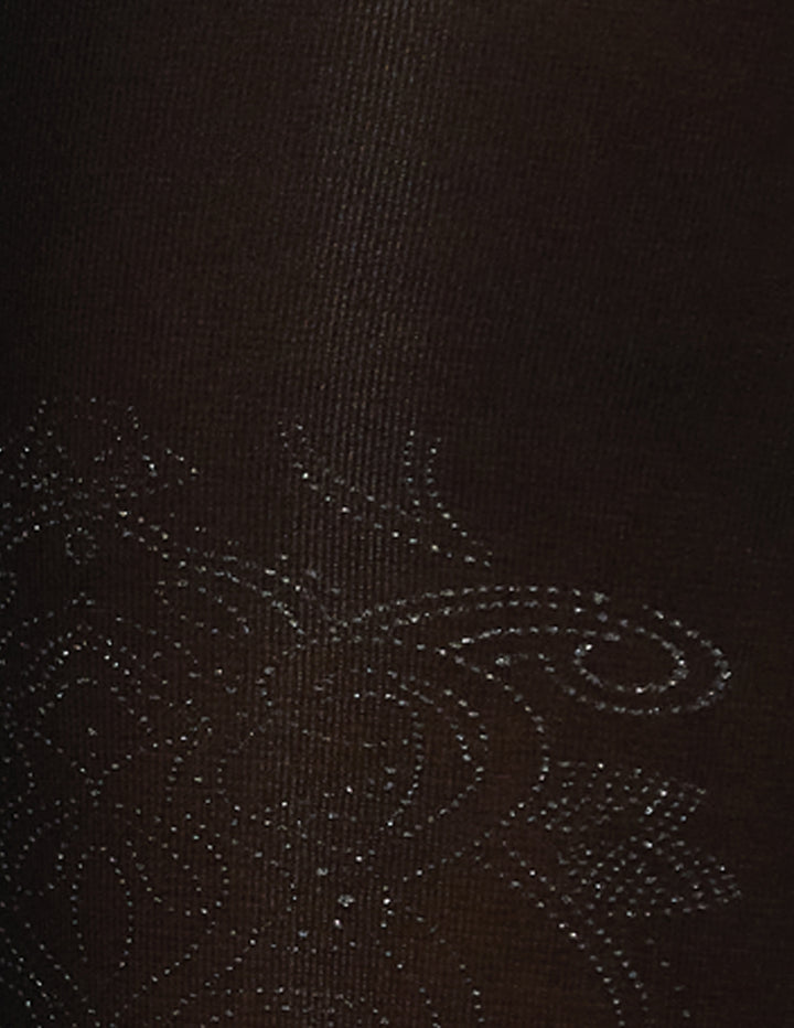 A detailed view of a foil brocade pattern on a black fabric.