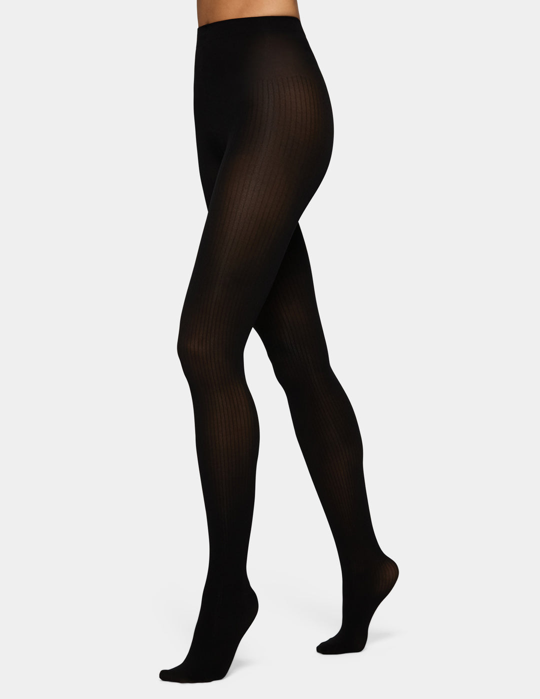 A model wearing black ribbed tights against a light grey background.