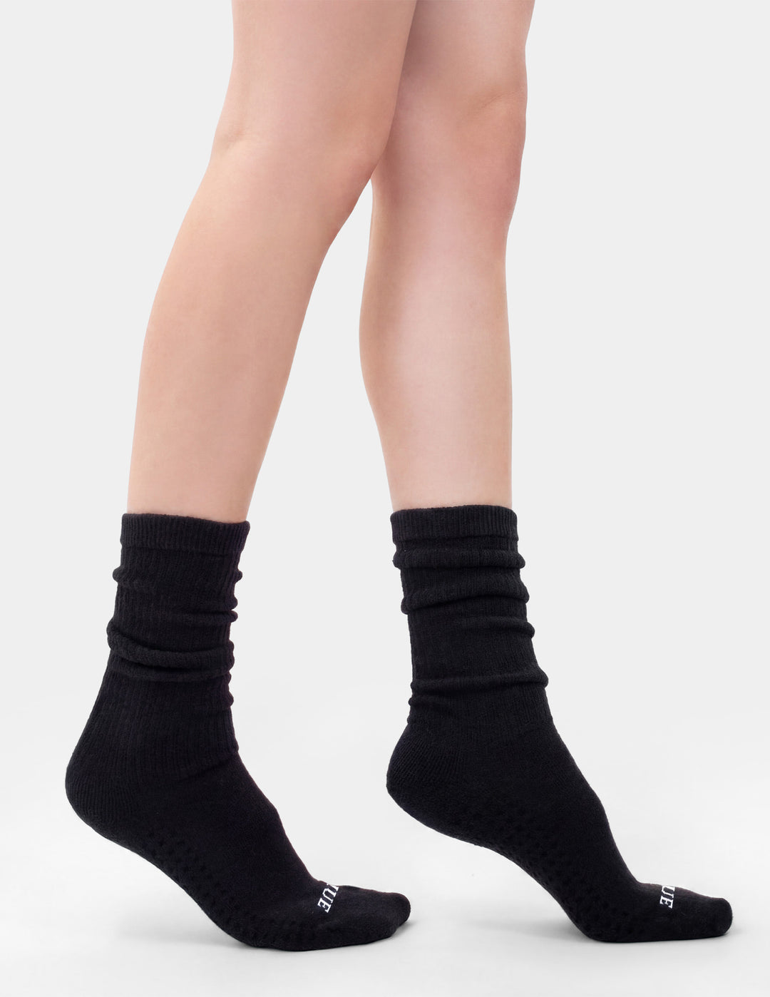 Black socks worn by a person on a white background