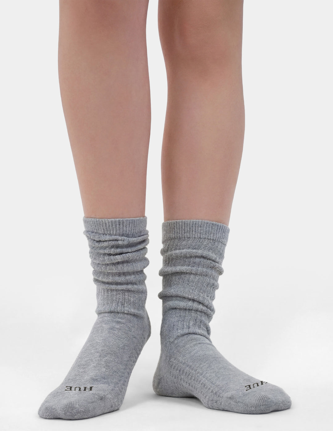Gray socks worn by a person on a white background