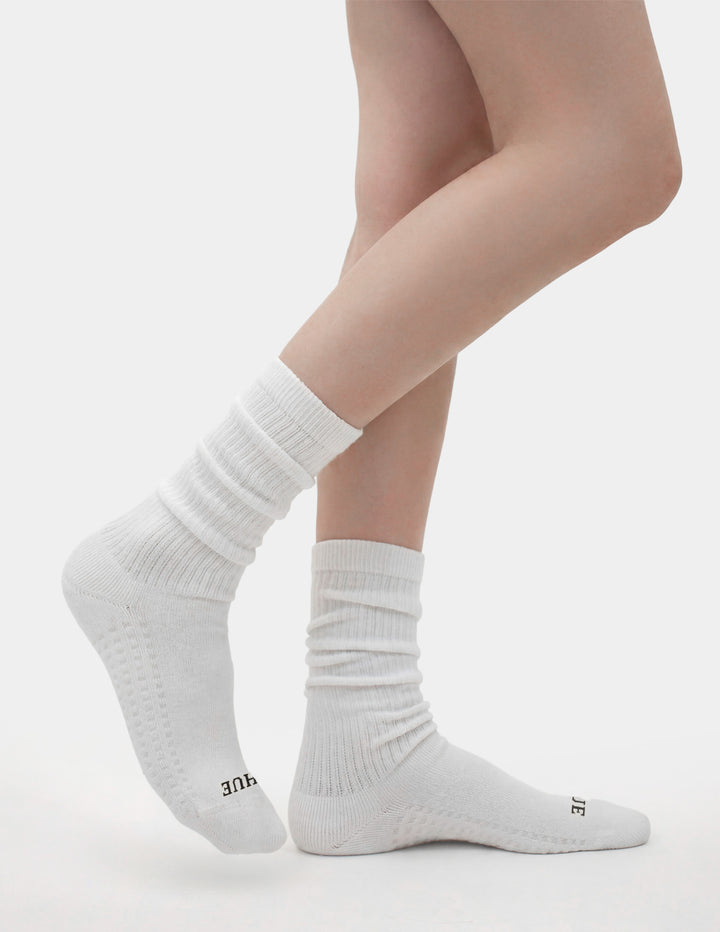 White socks worn by a person on a light gray background