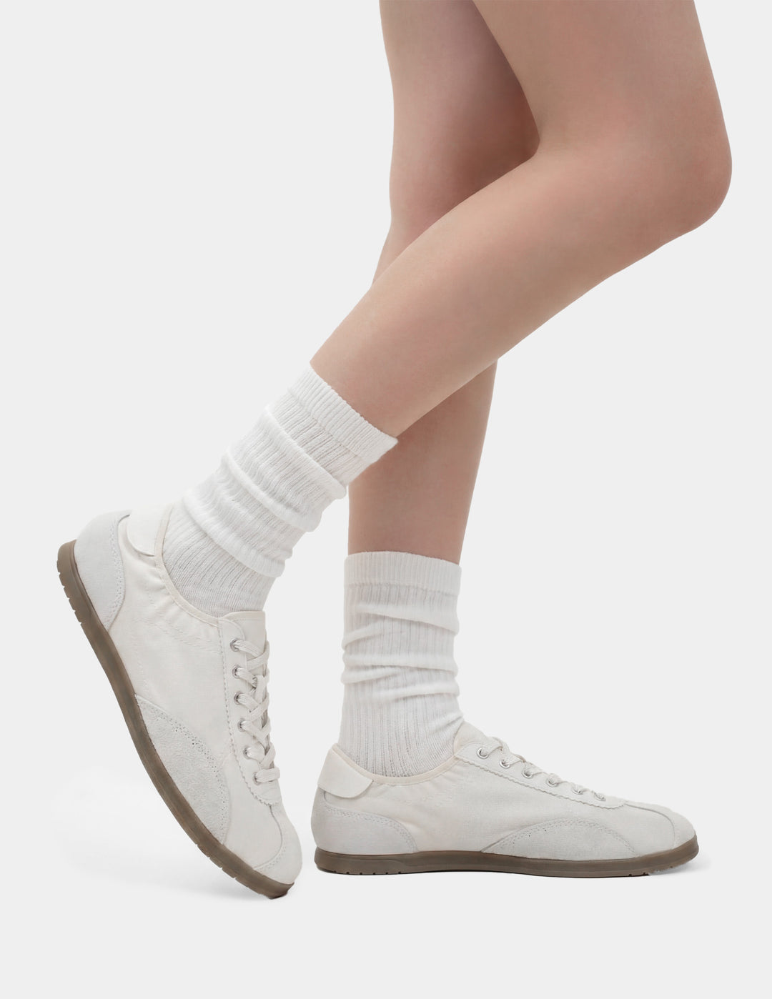 White sneakers and socks on a plain background