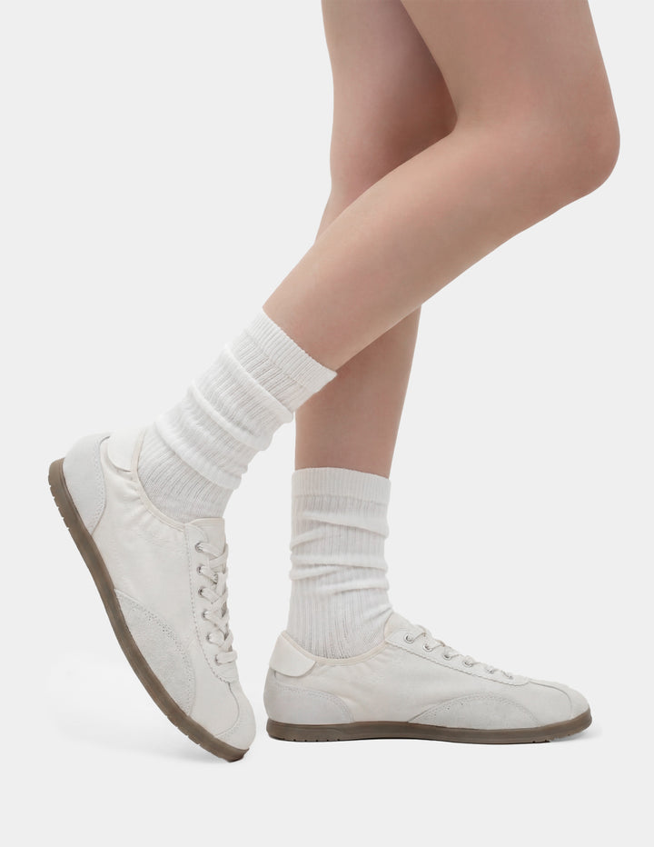 White sneakers and socks on a plain background