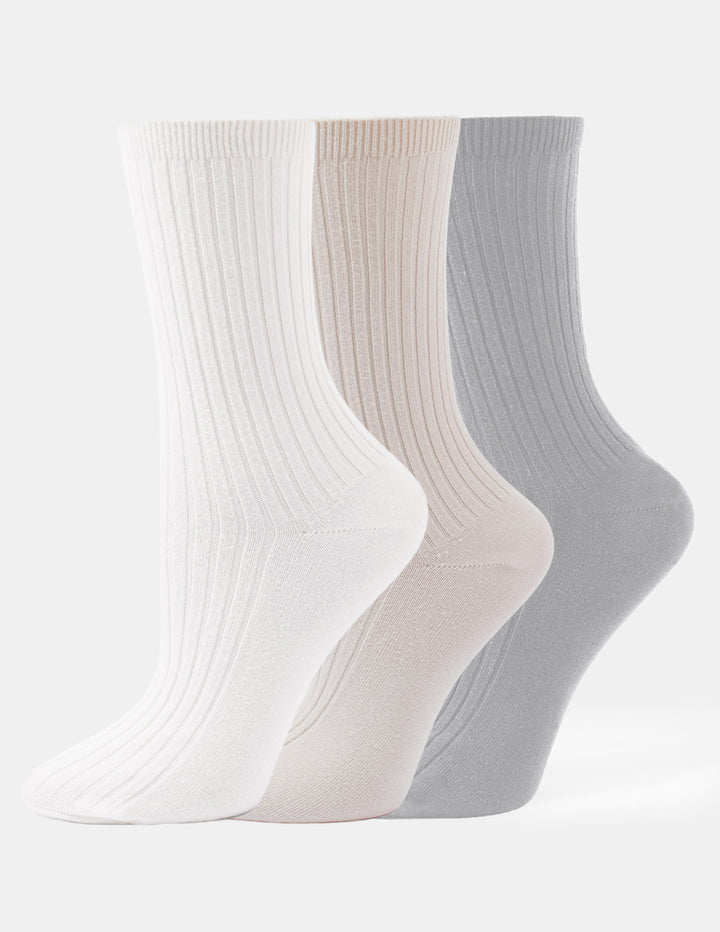 Three pairs of crew socks in ivory, beige, and light grey displayed against a light gray background.