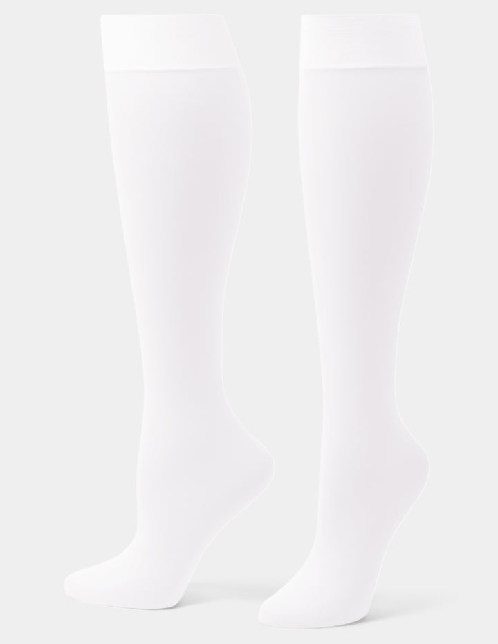 A pair of white over-the-knee socks shown on invisible forms against a light gray studio background.