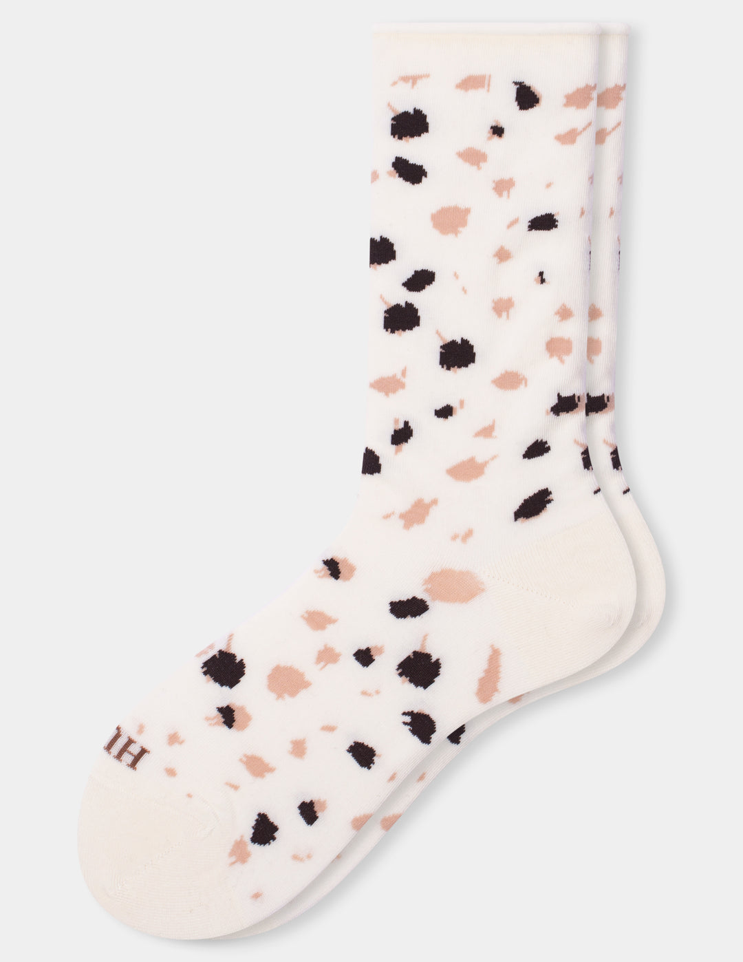 A pair of ivory crew socks with a scattered animal print pattern of black and pink spots, shown against a light gray background.