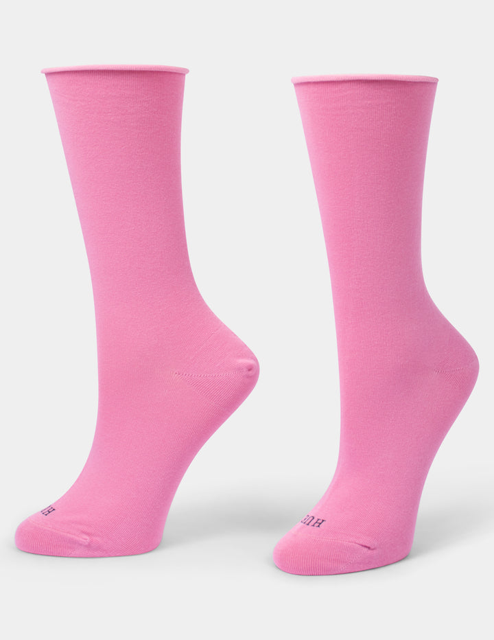 A pair of bright pink crew socks displayed on foot forms against a light gray background.