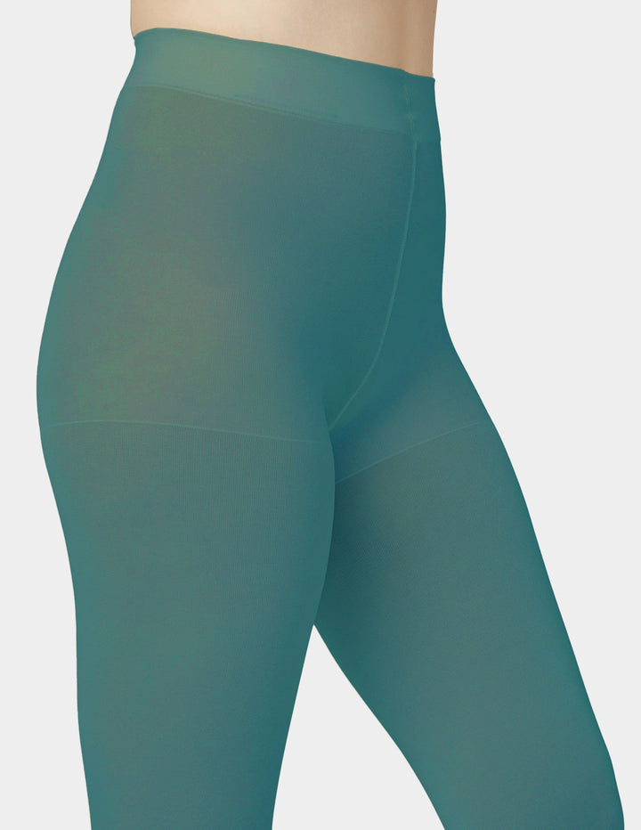Close-up of a person wearing high-waisted teal tights against a light gray background.