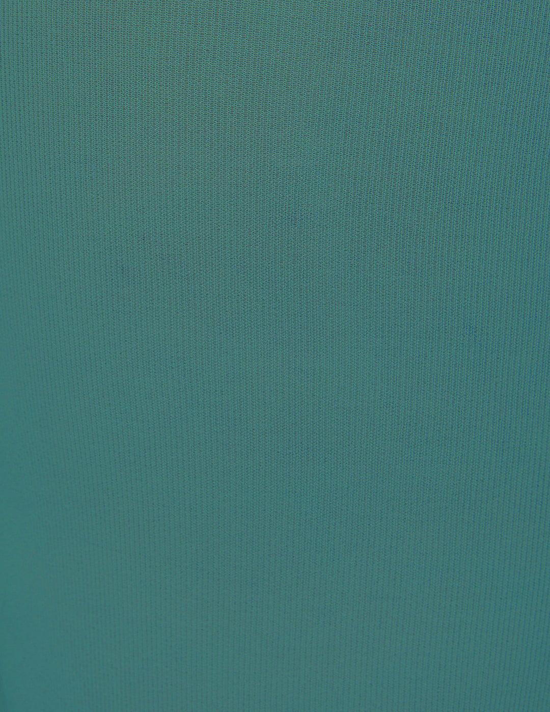 A close-up of a solid teal fabric.