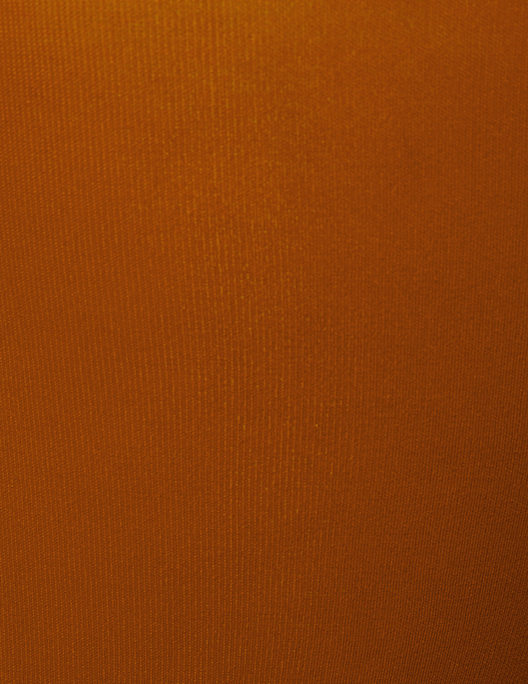 A close-up of a solid orange textured fabric.