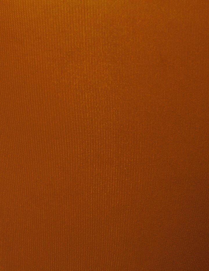 A close-up of a solid orange textured fabric.