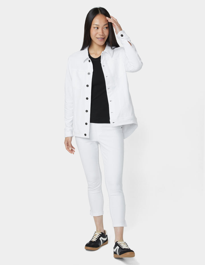 Woman wearing a white jacket and pants with a black shirt on a white background