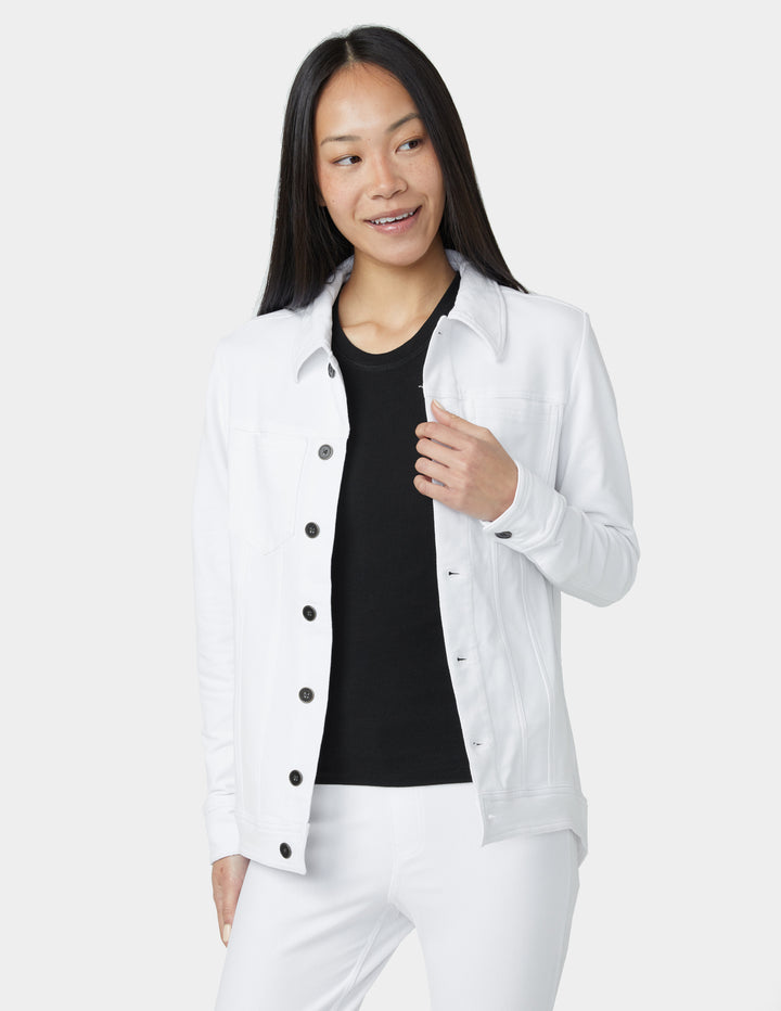Woman wearing a white jacket over a black shirt on a white background