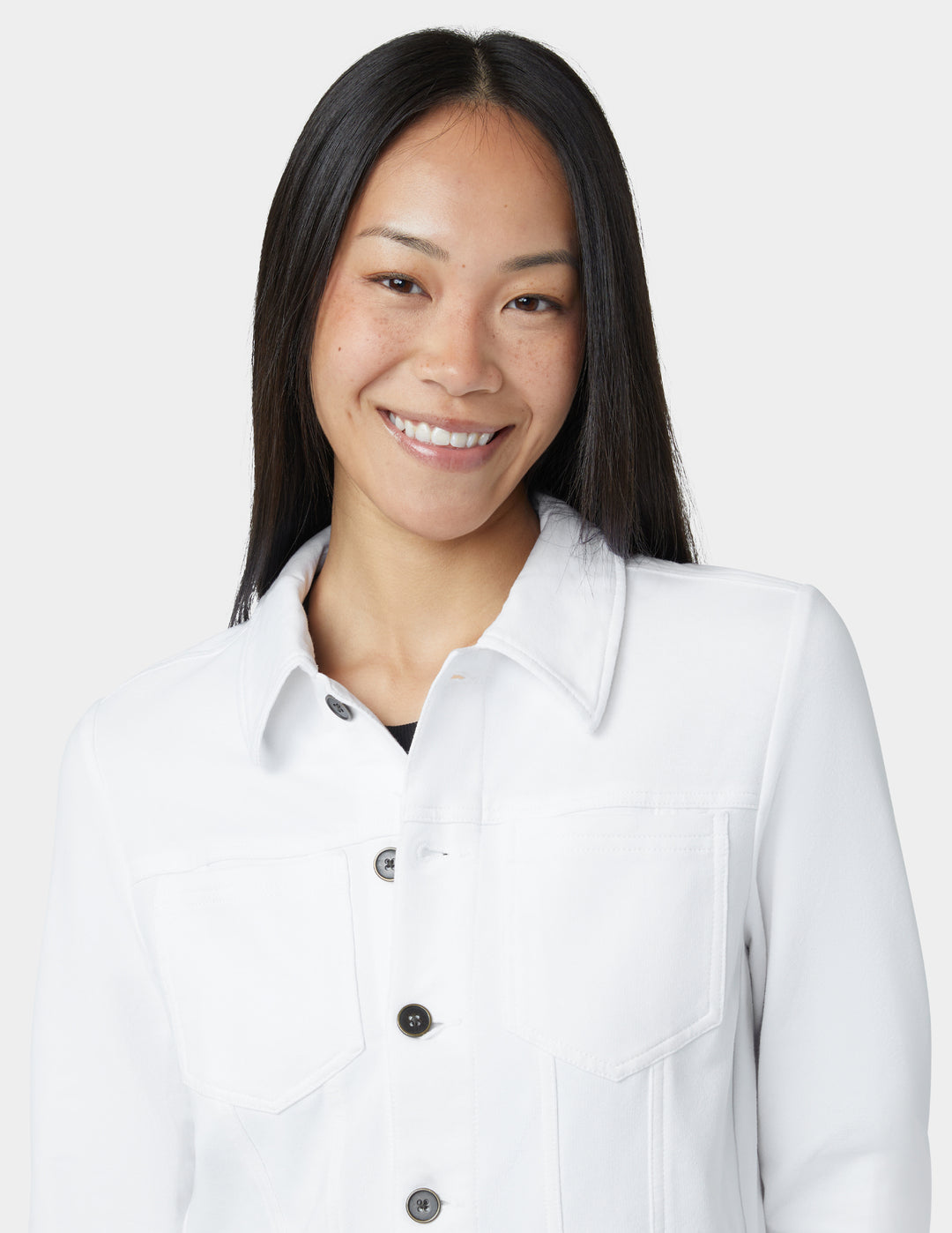 Woman wearing a white jacket on a plain background