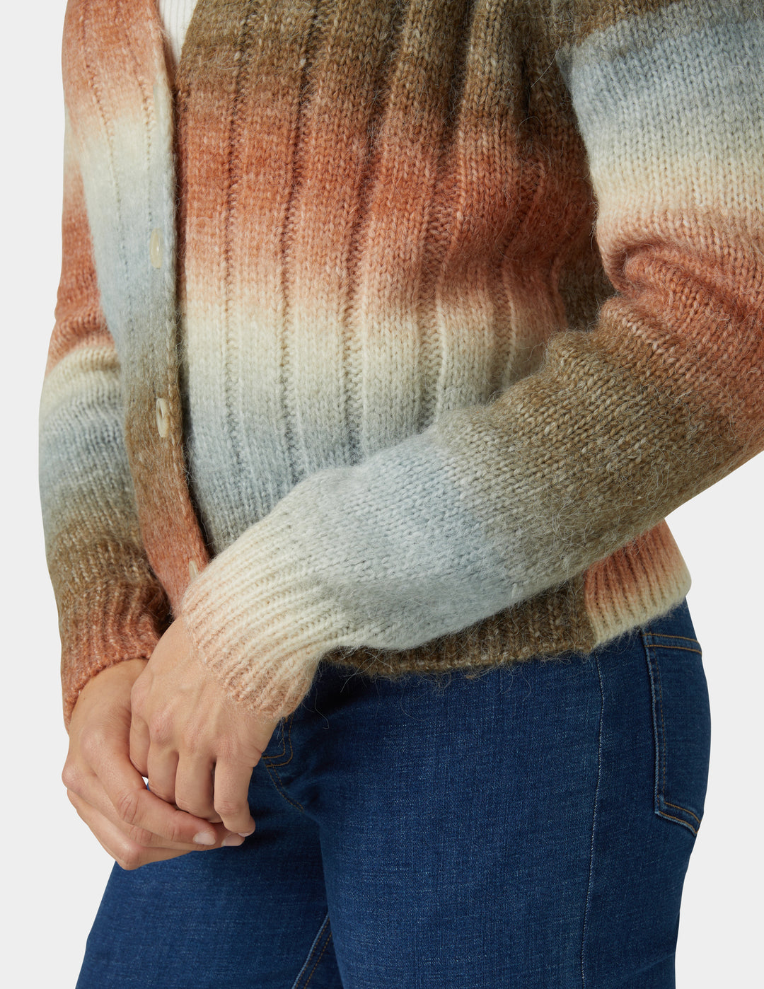 Multicolored sweater with a gradient pattern worn by a person, on a plain background