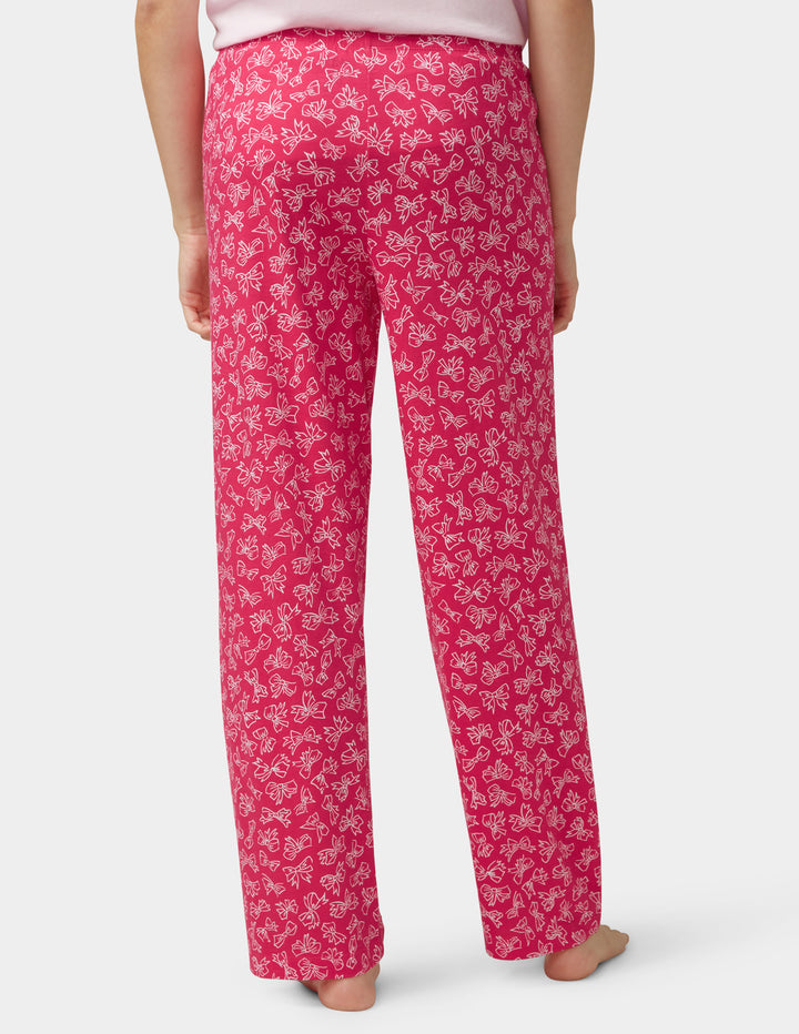 Pink bow design pants worn by a person on a white background