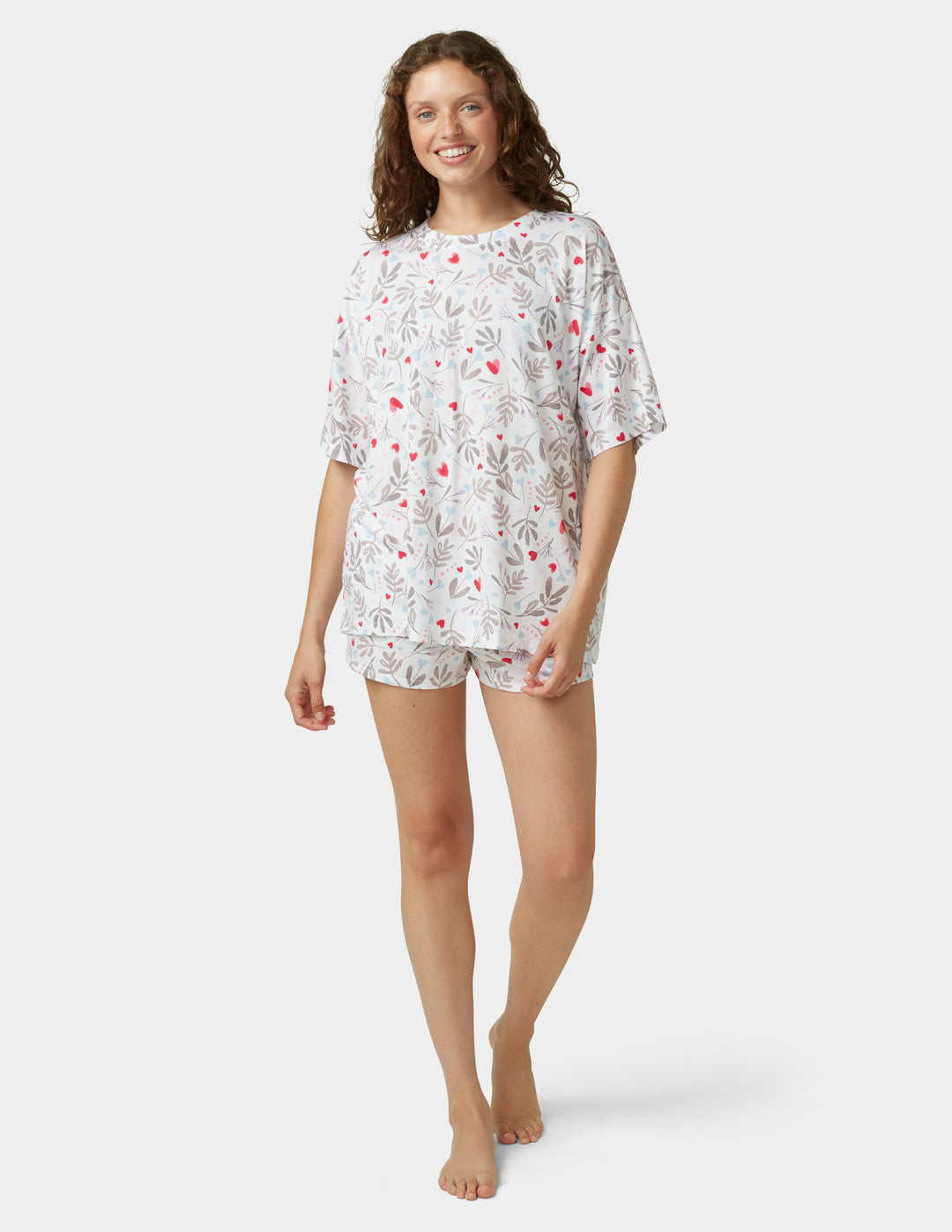 Woman wearing white pajama set on a white background