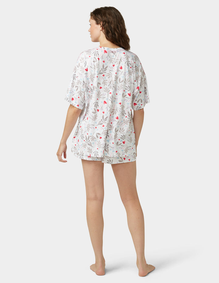 Woman wearing white pajama set on a white background