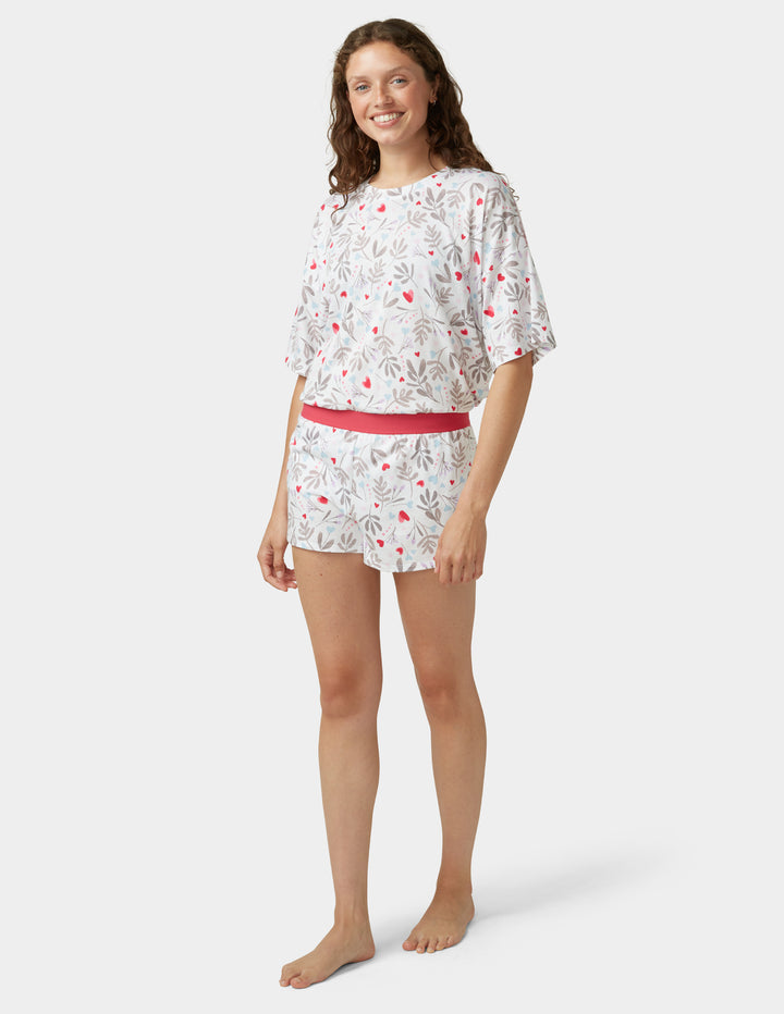 Woman wearing white pajama set on a white background