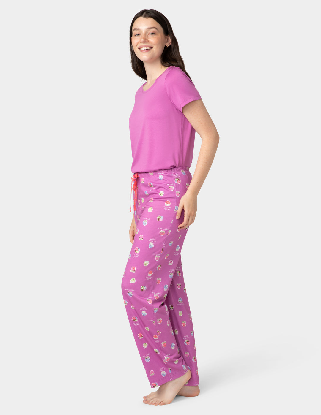 Woman wearing a pink pajama set with a white background