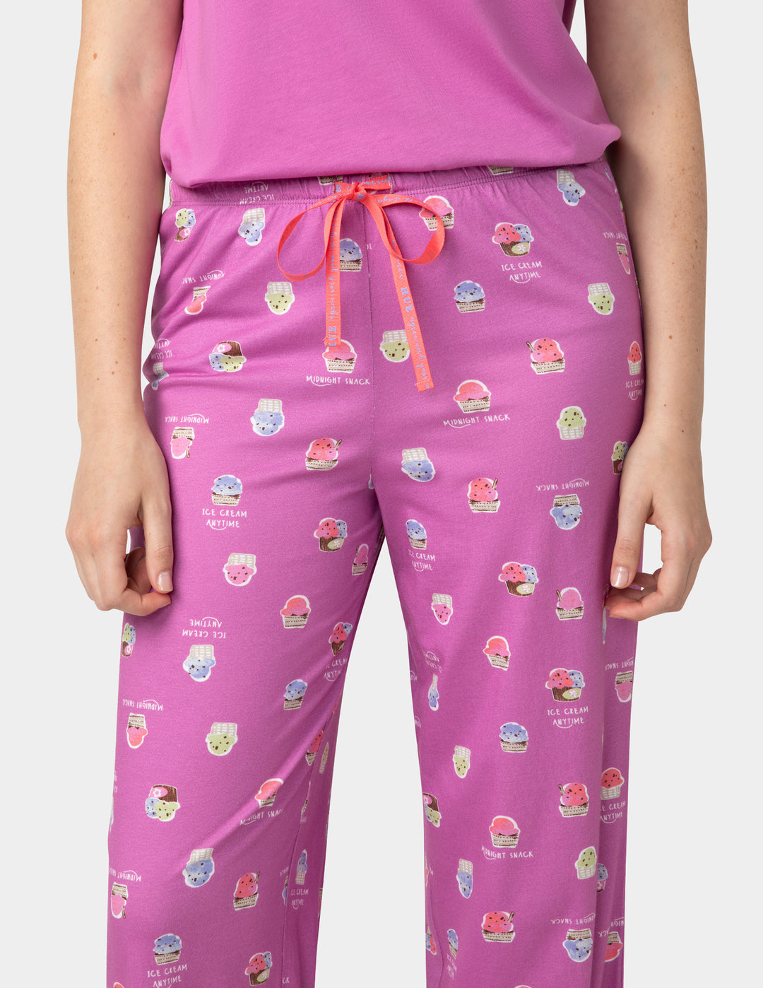Pink pajama set with colorful graphics on a white background