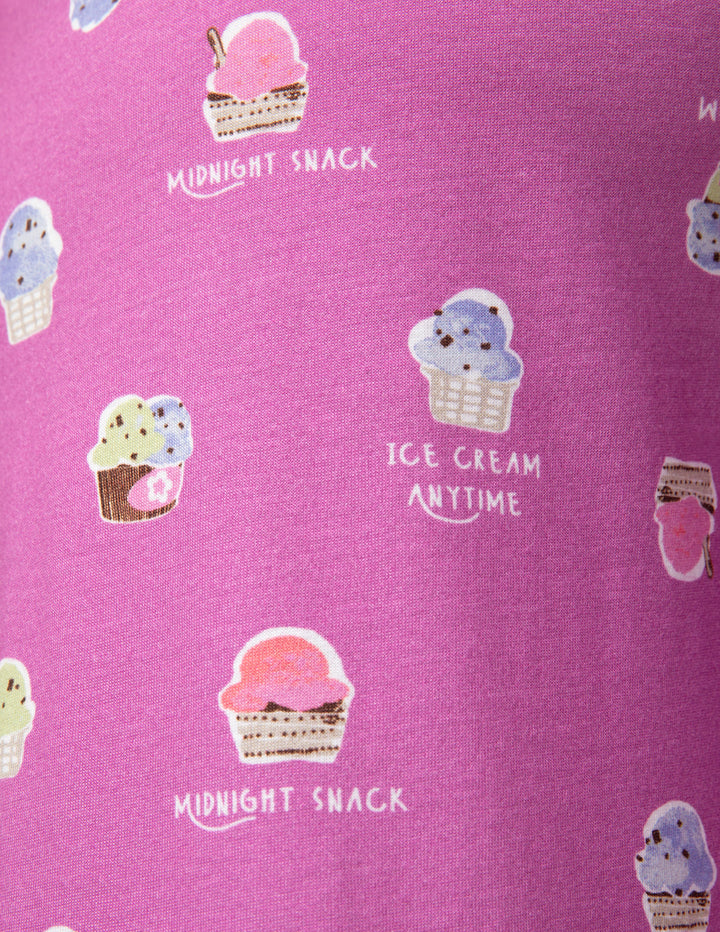 Pink fabric with ice cream cone and 'midnight snack' text pattern