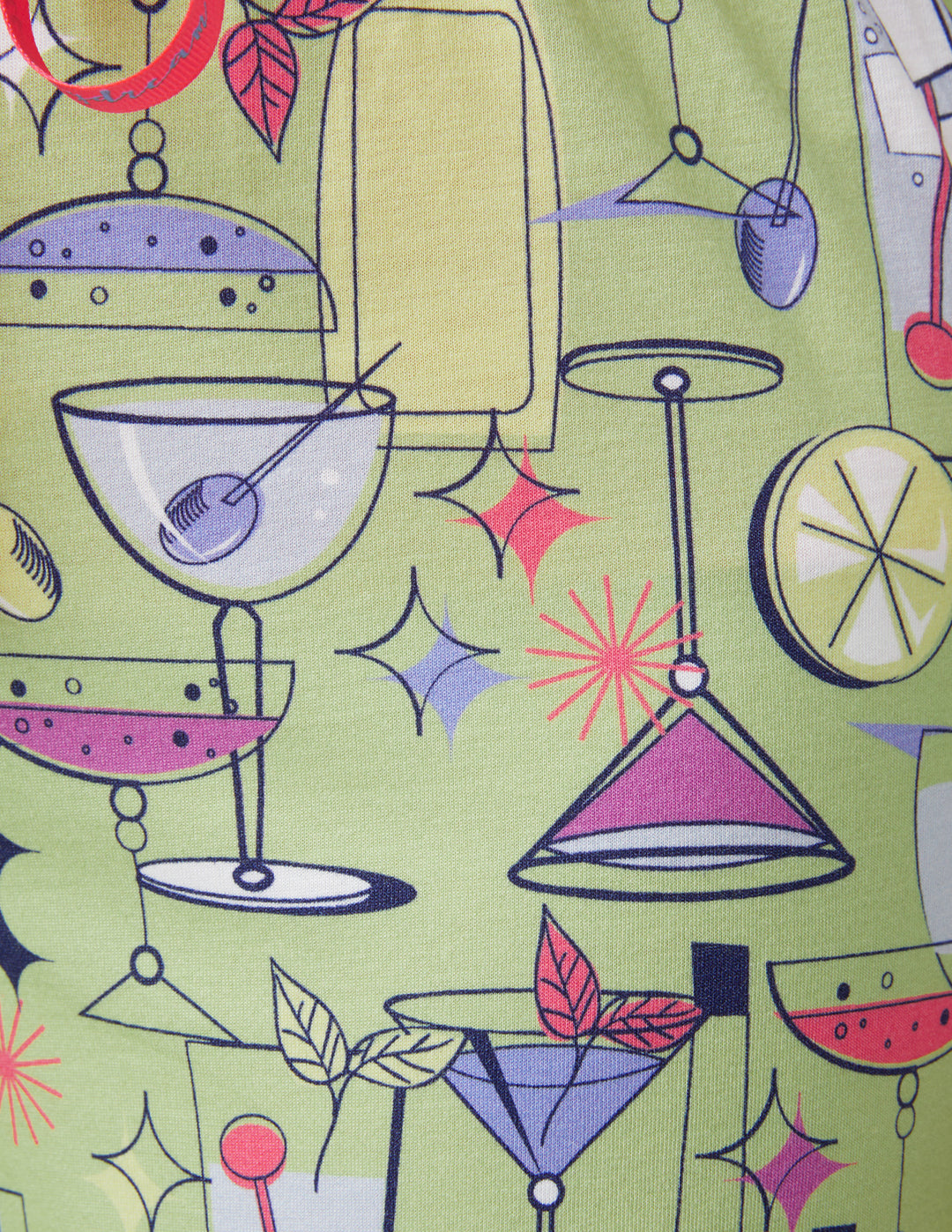 Patterned fabric with cocktail glasses, lemons, and limes on a green background