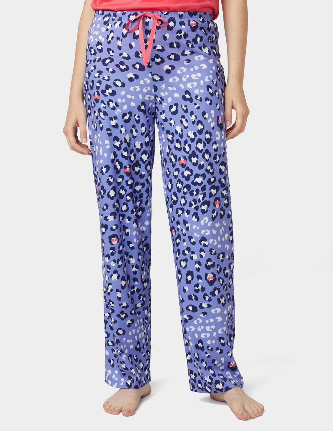 Purple leopard print pajama pants worn by a person on a white background