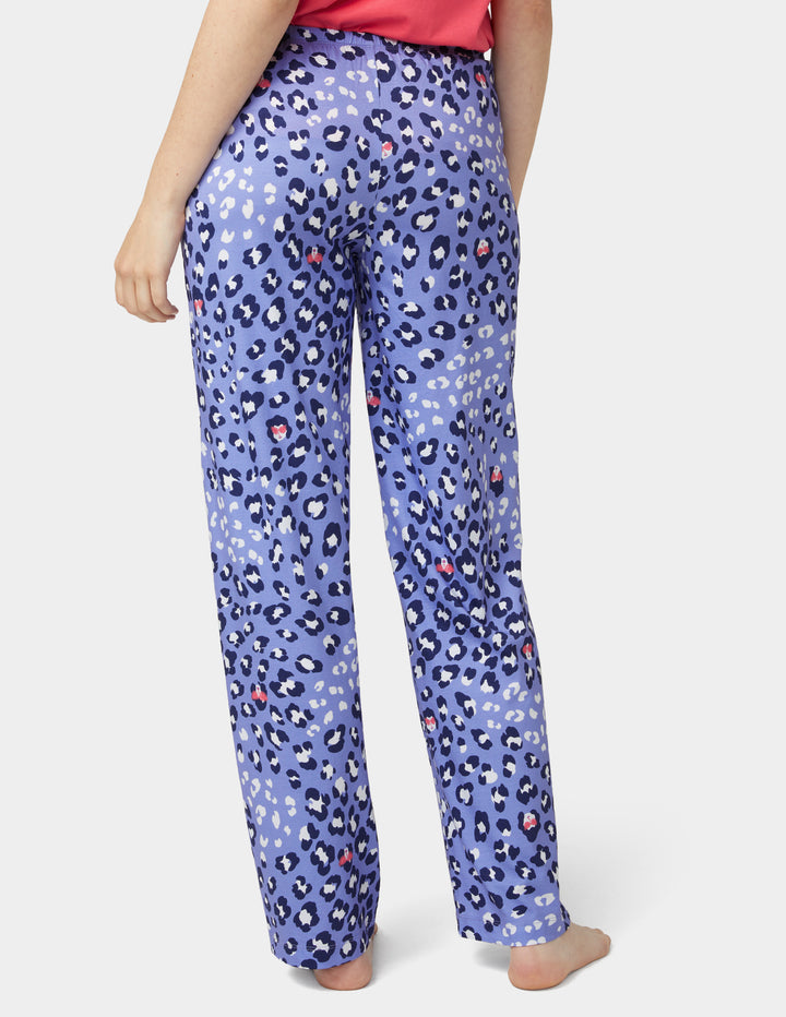 Person wearing blue leopard print pants on a white background