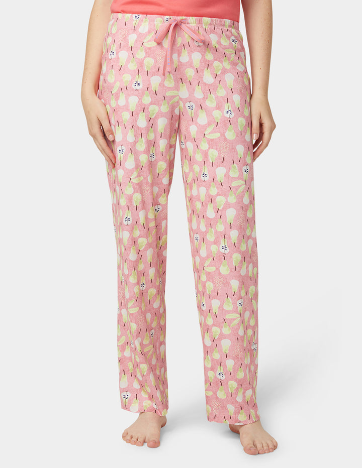 Pink pajama pants with a pattern worn by a person on a white background