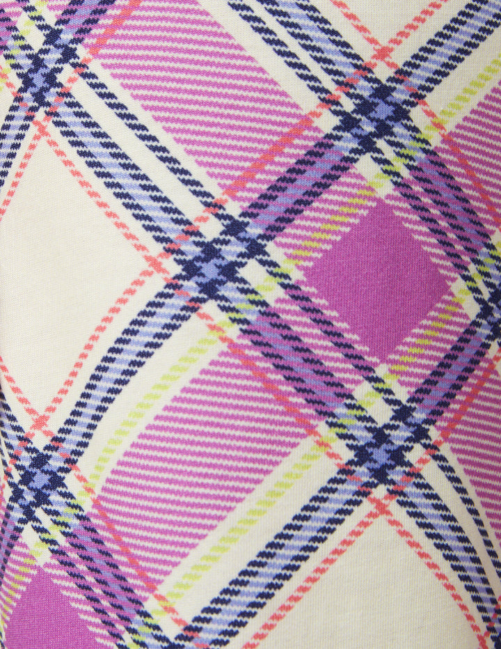 Close-up of a colorful plaid pattern with pink, purple, and yellow lines on a beige background.