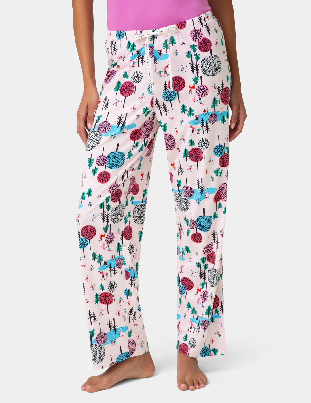 Floral patterned pajama pants worn by a person on a white background