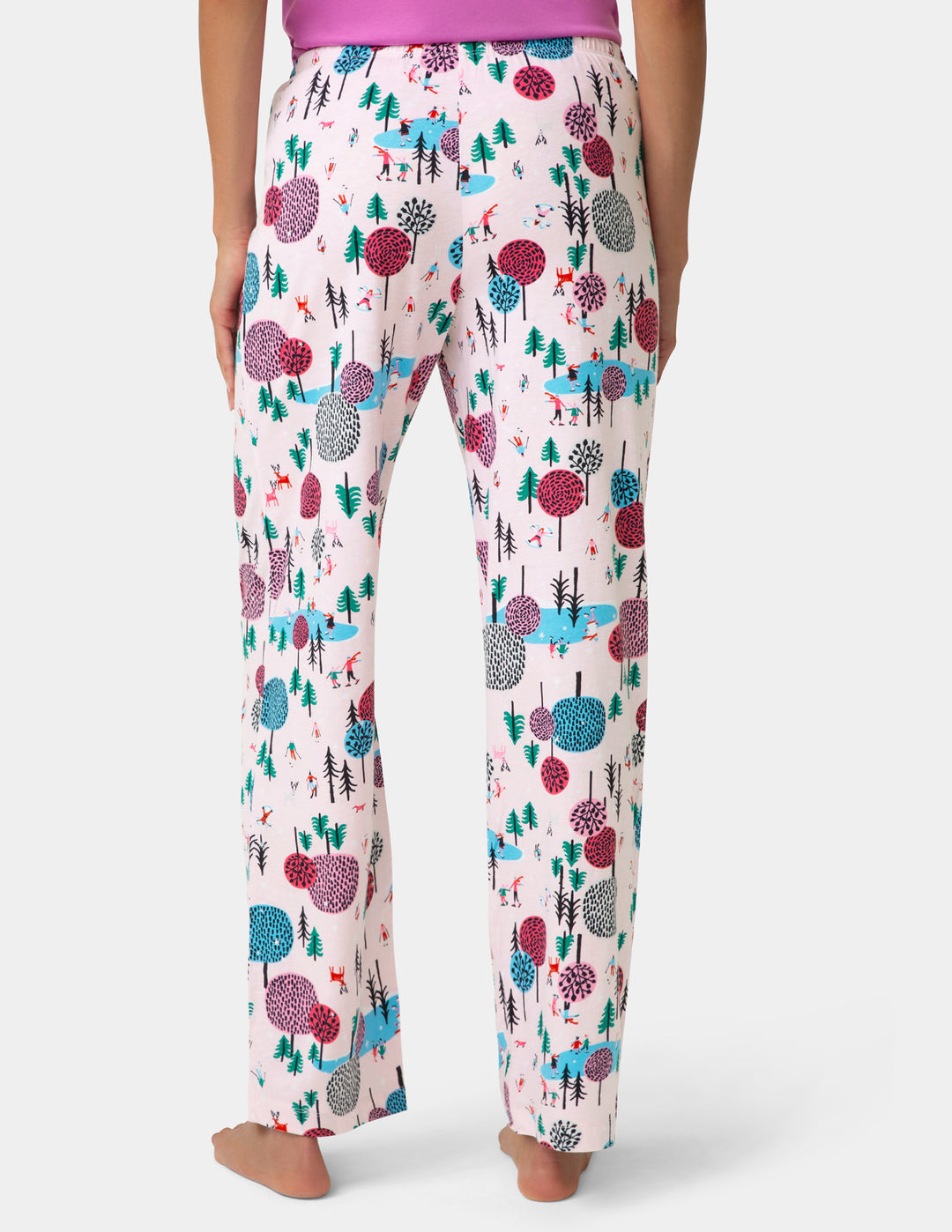 Floral patterned pajama pants worn by a person on a white background