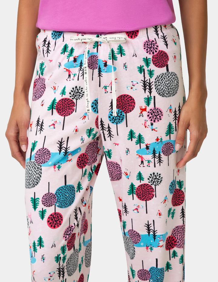 Pajama pants with a forest pattern on a plain background