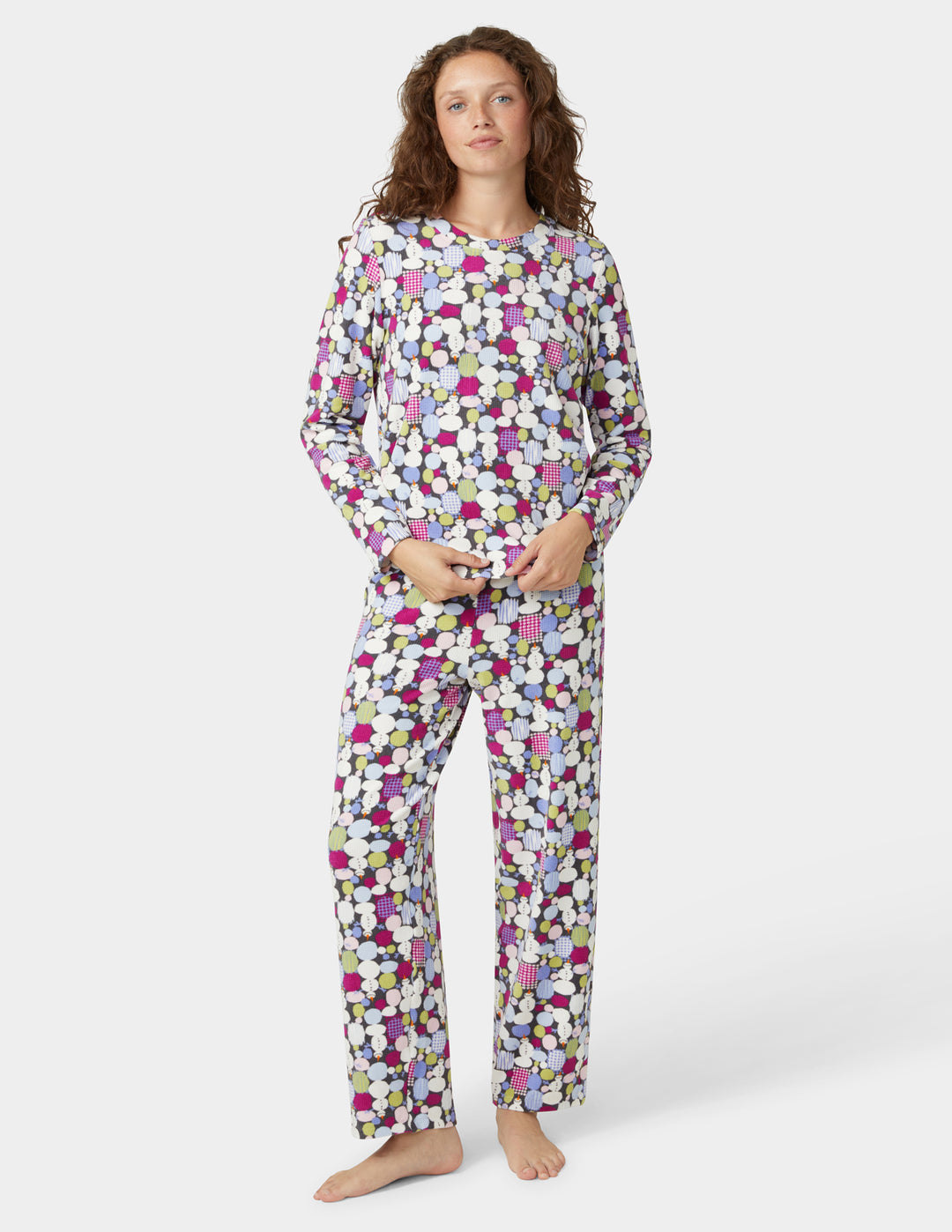 Woman wearing a colorful pajama set on a white background